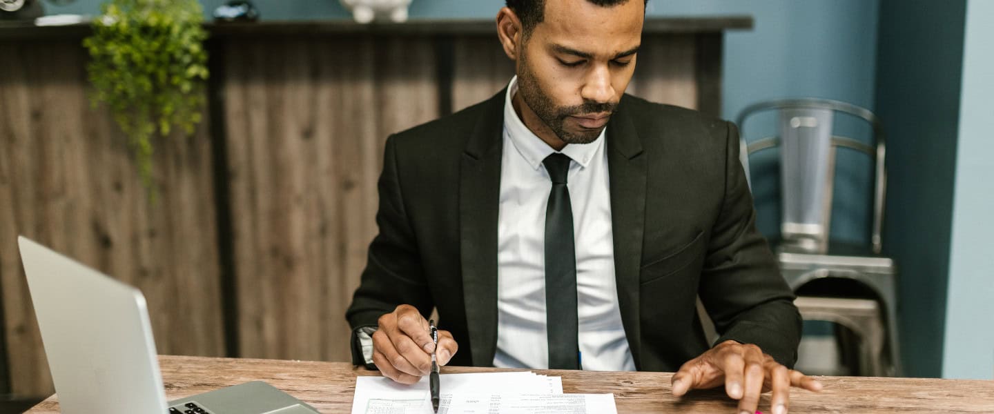 Accountant examining business financial statements before introducing commercial loan solutions