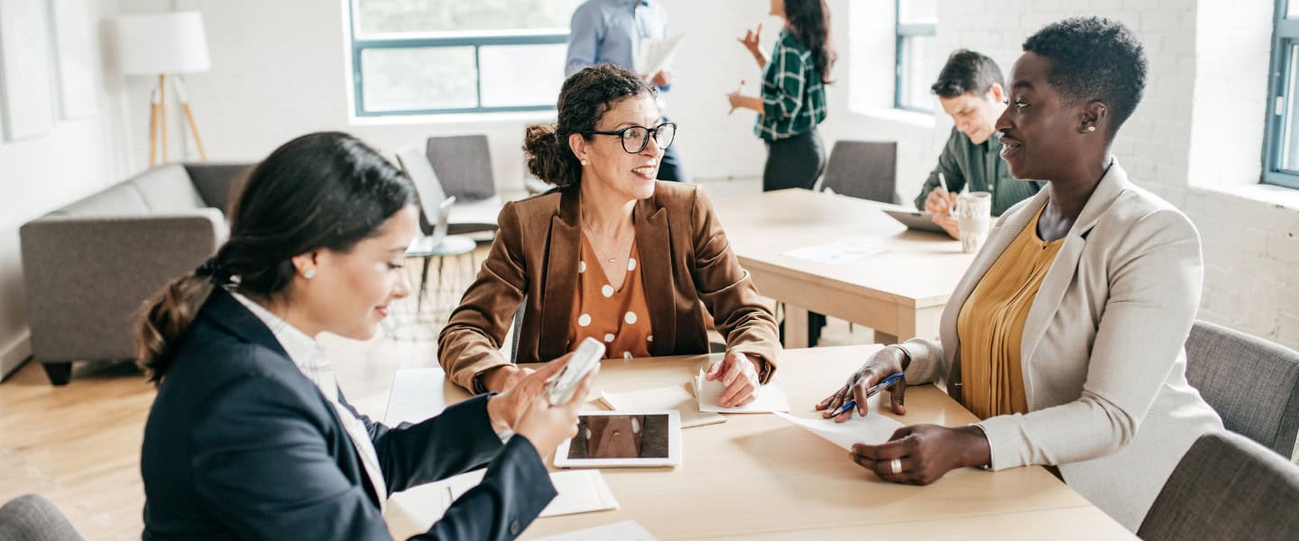 Advisory discussion between professionals on capital strategy and commercial loan placement