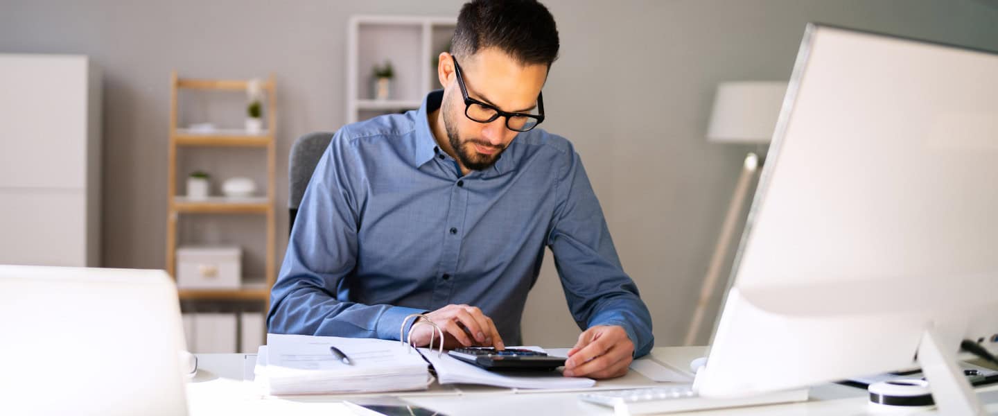 Accountant reviewing financial performance metrics to guide commercial loan advisory decisions