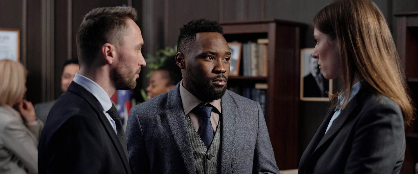 Business loan broker discussing loan terms with lenders and clients