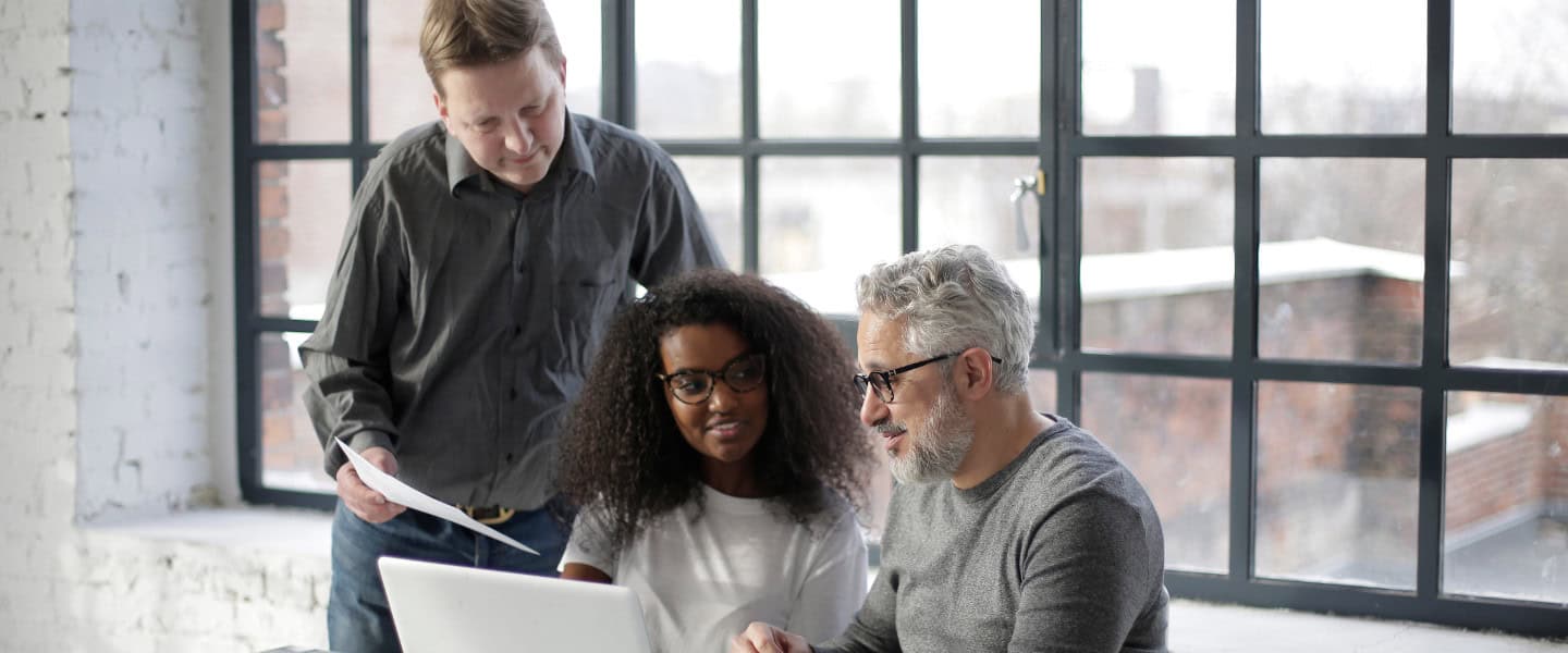 Commercial lending advisors analyzing loan application on laptop