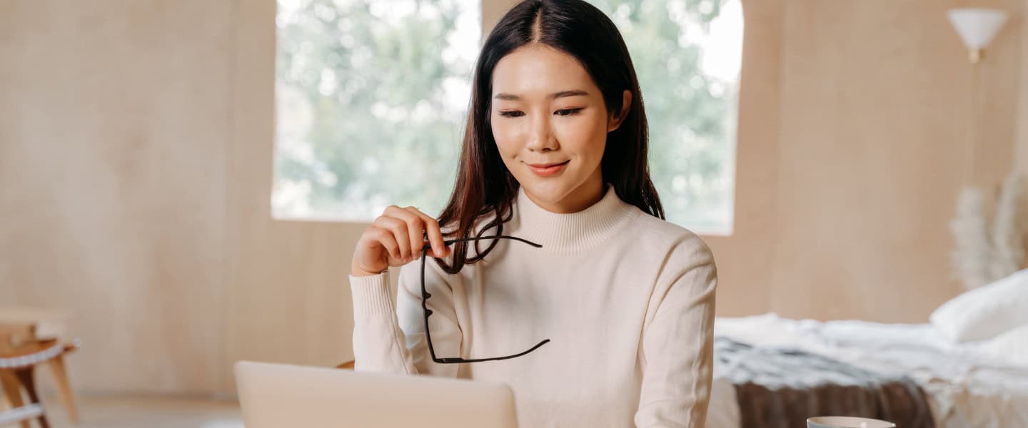 Loan professional reviewing commercial lending data on laptop