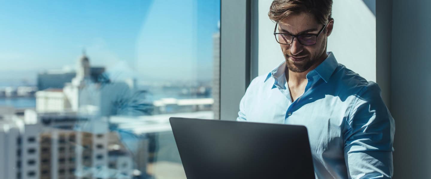 banker working on laptop planning move to commercial loan broker
