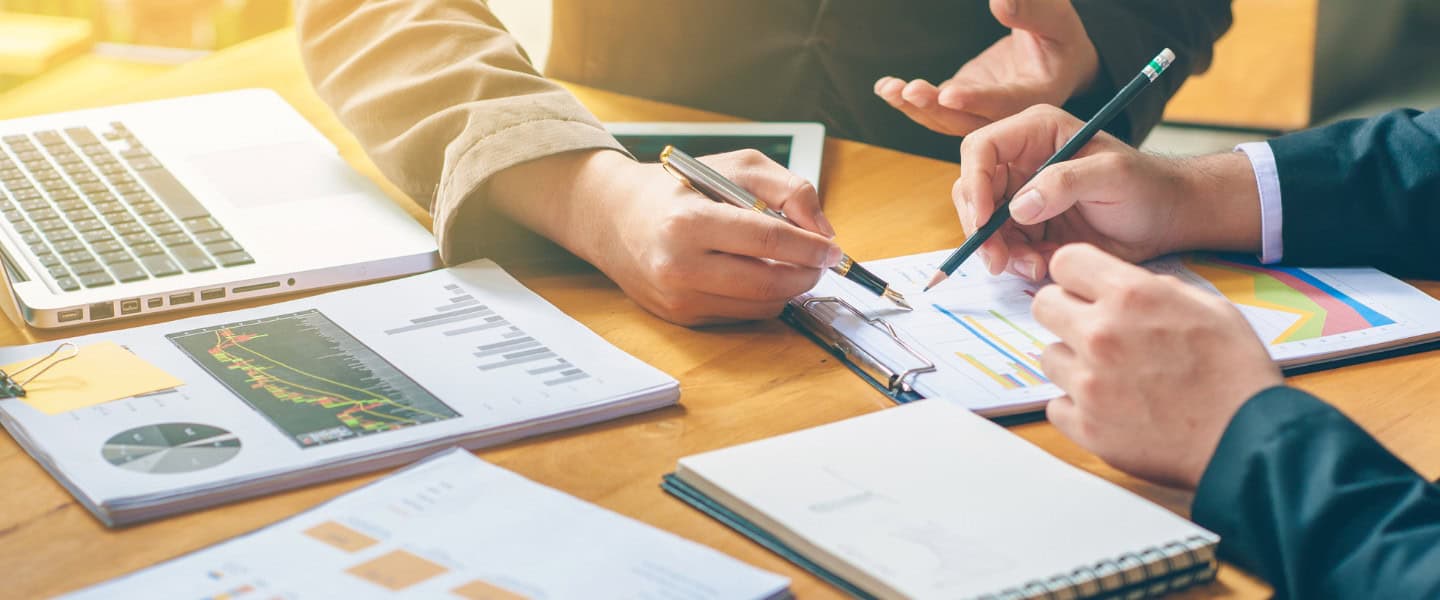 professionals reviewing loan documents and financing strategy